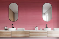Cherry Blossom Panel wallpaper mural in rose-pink ombre behind two oval mirrors and dual sinks on a wood bathroom vanity
