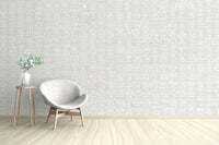 White tribal motif on a light grey wallpaper mural design.
