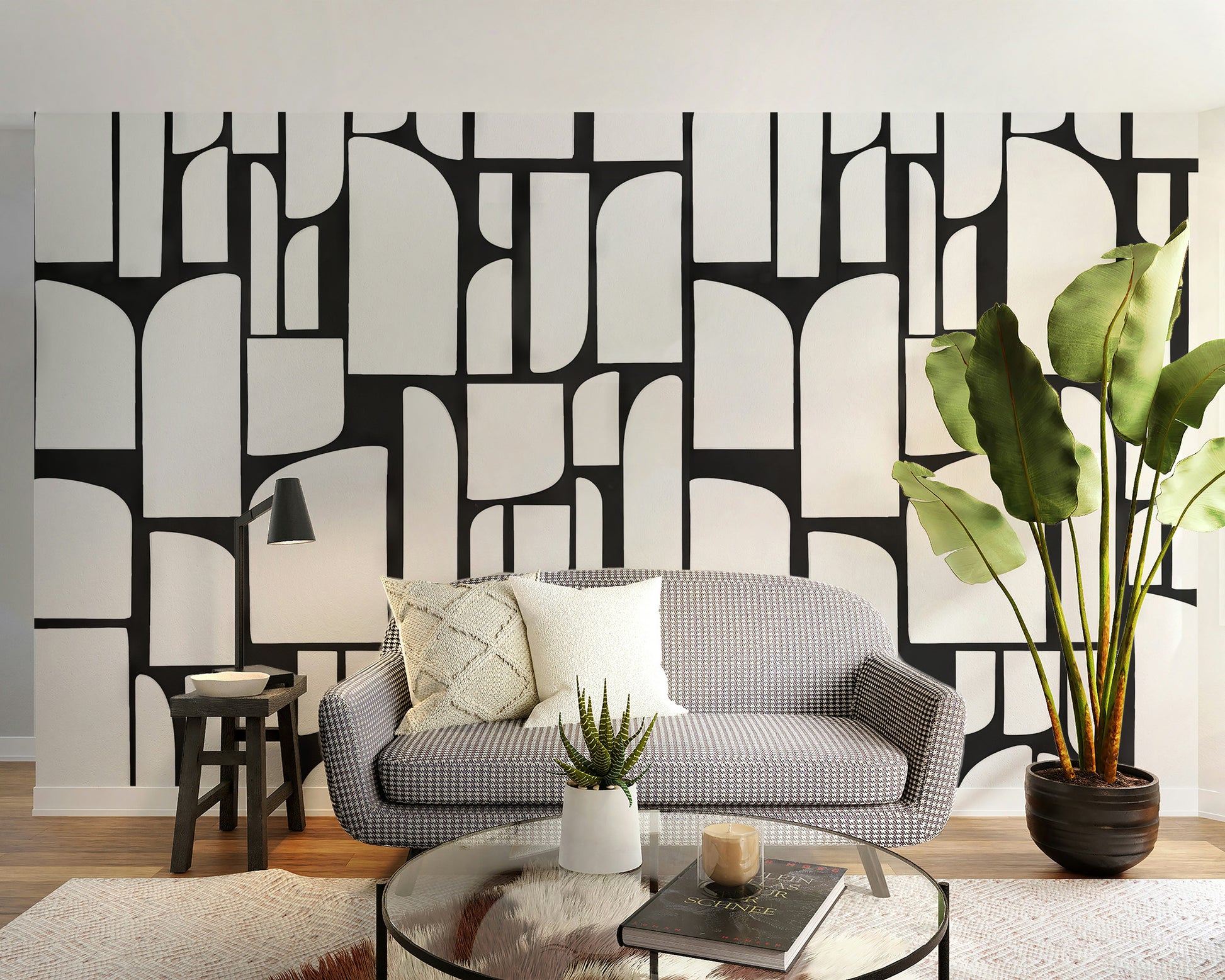 Monochrome Mosaic Tiles wallpaper mural in cream and black behind a grey check loveseat in a cozy living room