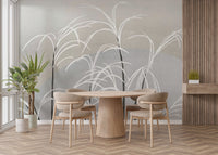 Moon and Grass wallpaper mural in grey tones behind a round wood dining table and chairs with a potted plant