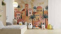 Terracotta House wallpaper mural of a clay village with palms behind a low wood bed and white bear cushion in a kids room