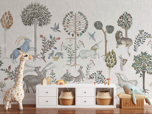Whimsical Wildlife wallpaper mural with folk-art deer, lion and unicorn on beige behind a white sideboard and plush giraffe