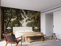 Woodcut Green Nature Botanical wallpaper of a dark green forest behind a beige upholstered bed in a modern bedroom