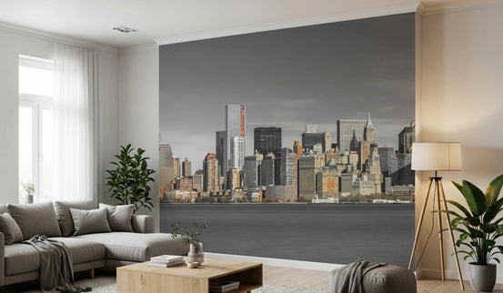 Skyline of New York City mural over a gray sectional sofa and wood coffee table in a living room