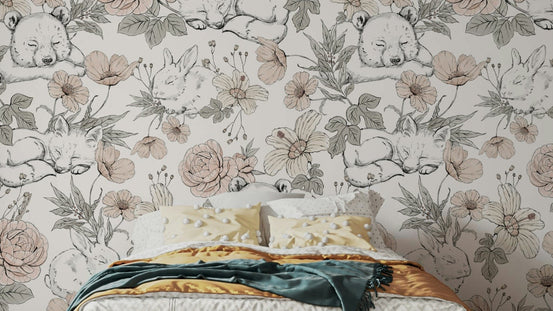 Sleeping Woodland wallpaper mural of bear cubs and bunnies in pink florals above a bed with yellow pillows