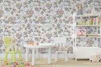 Sleeping Woodland wallpaper mural in a playroom with a round table, green chair and lamb plush