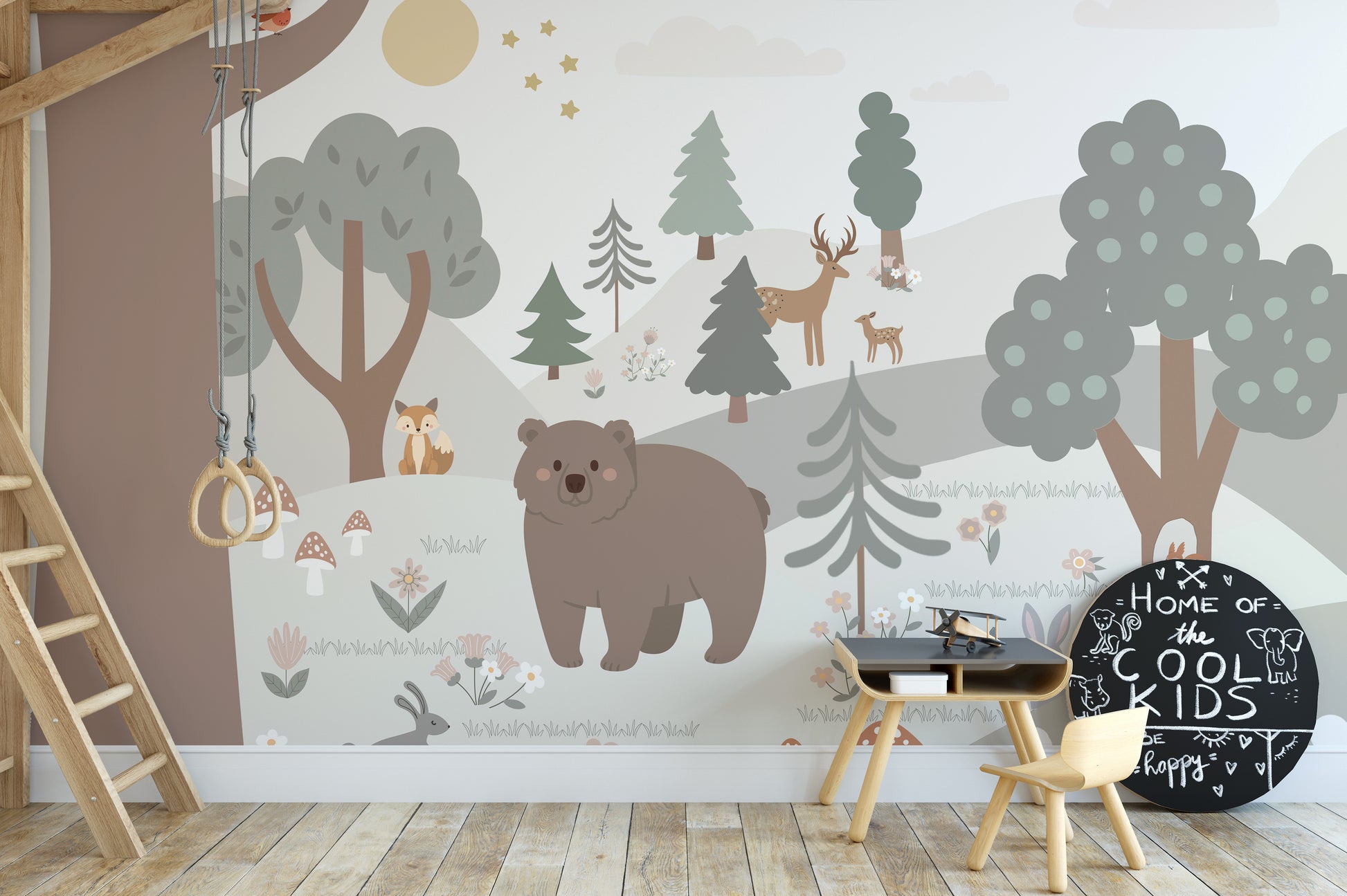 Snow Forest Kids Room wallpaper mural styled as a living room feature wall behind a sofa and seating in a multicolour palette