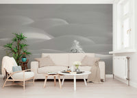Snowscape Serenity wallpaper mural of pale snowdrifts behind a cream sofa and palm plant in a bright living room