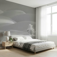 Snowscape Serenity wallpaper mural of gray winter snowdrifts behind a gray upholstered bed in a calm bedroom