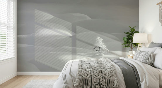 Snowscape Serenity wallpaper mural of soft gray snowy hills and a snowy pine behind a white bed in a bedroom