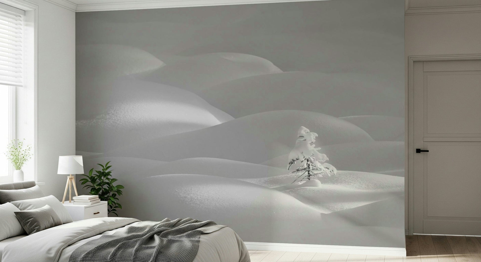 Snowscape Serenity wallpaper mural of soft white snow dunes behind a gray-dressed bed in a minimal bedroom