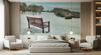 Solitary bench, pristine snow field, charming winter scene wall mural.