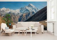 Home office backdrop with snowy mountains and quiet sky mural behind a desk