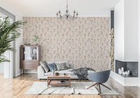 Soft Floral Whispers wallpaper of wildflowers behind a grey sofa and blue swivel chair under a chandelier