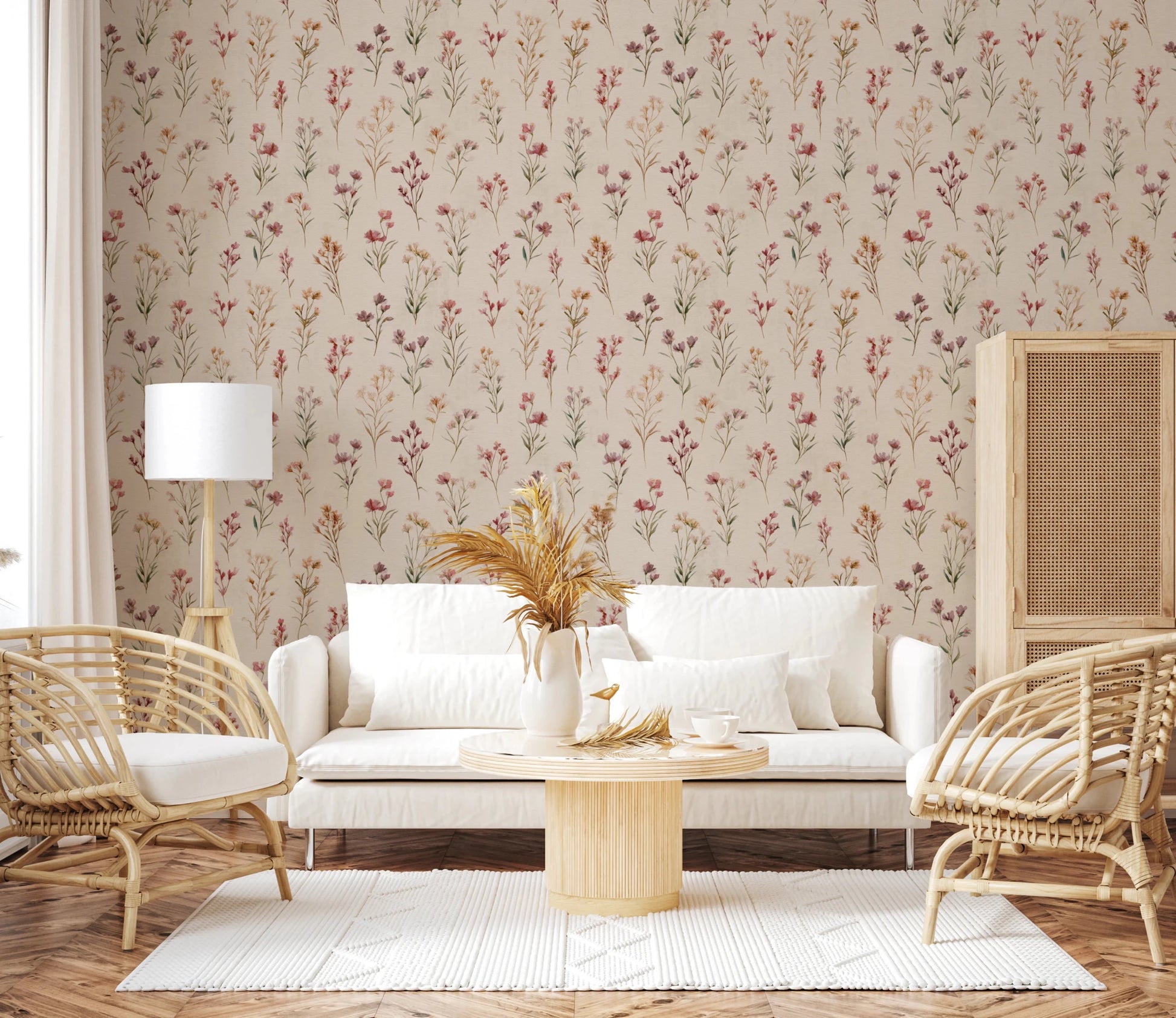 Soft Floral Whispers wallpaper of a wildflower pattern in a living room with a white sofa and rattan armchairs