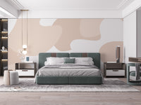 Soft Pastel Abstract wallpaper mural with peach organic shapes above a green upholstered bed in a bedroom
