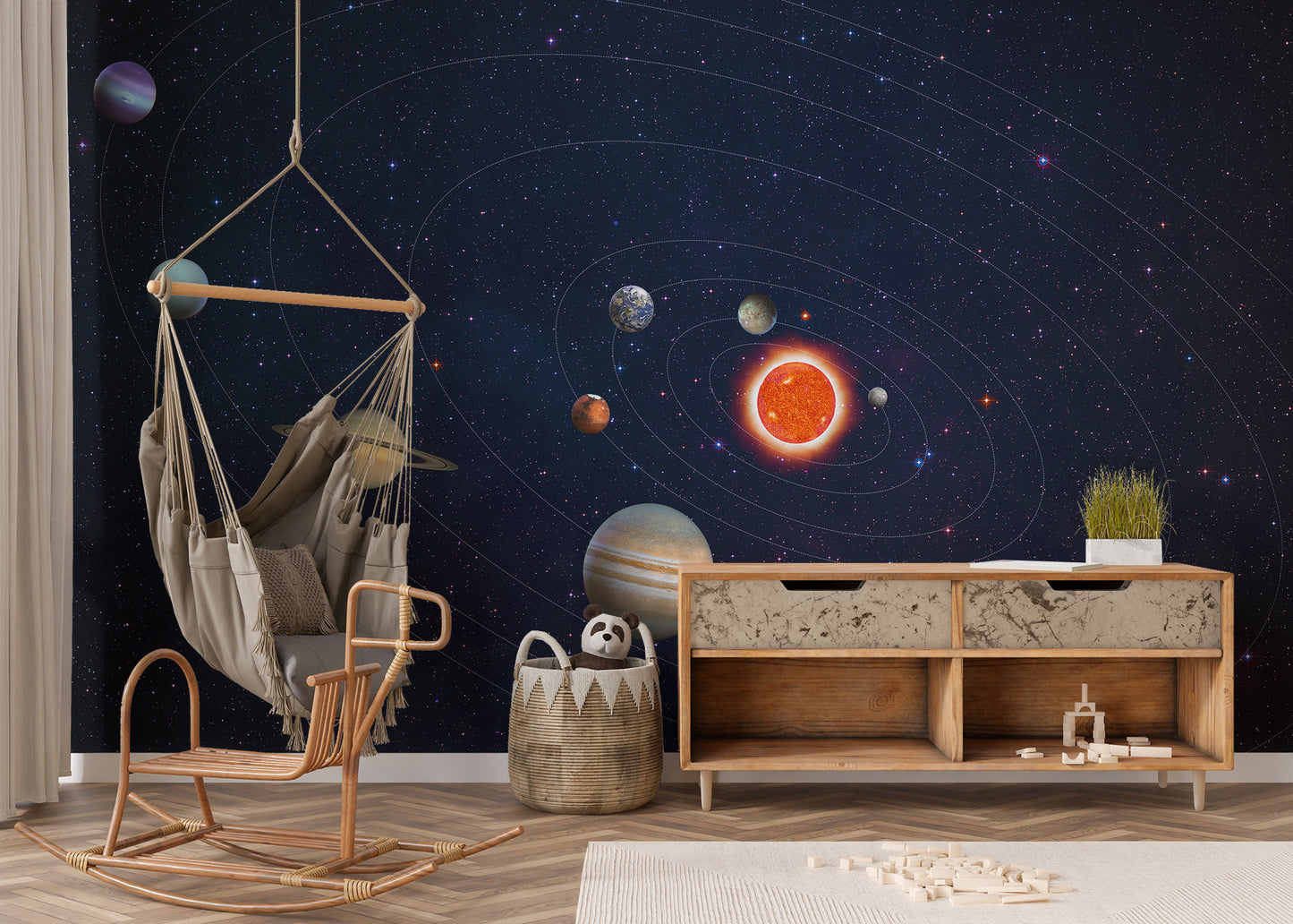 Solar System Planets Orbit wallpaper mural in a kids playroom with a macrame hanging swing chair and wooden sideboard