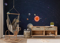 Solar System Planets Orbit wallpaper mural in a kids playroom with a macrame hanging swing chair and wooden sideboard