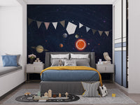 Solar System Planets Orbit wallpaper mural with sun and planets on starry sky in a kids bedroom with blue and mustard bedding