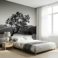 Lonely tree silhouette against bright sky in Solitary Woodland wallpaper print.