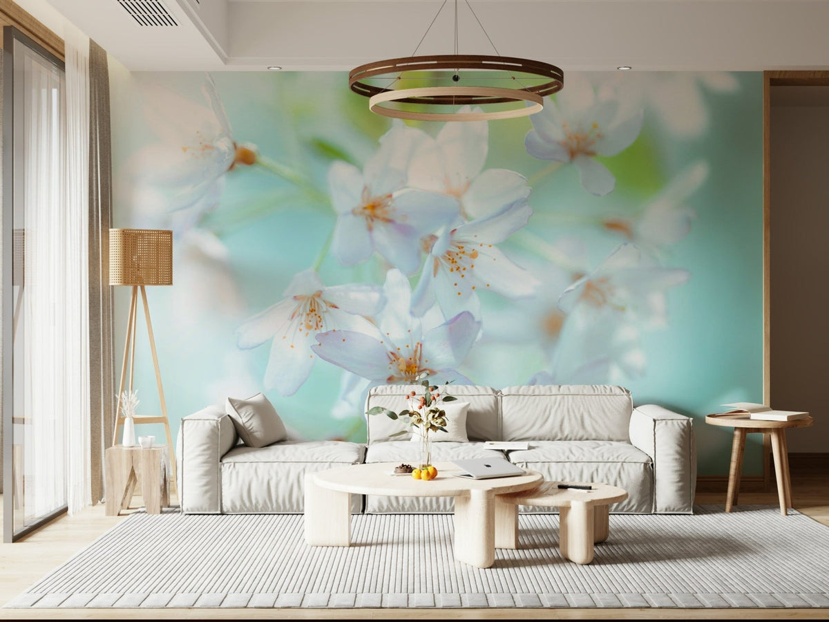 Springtime Blossoms wallpaper mural of soft white blooms on mint above a white sofa and round wood table