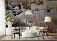 Stone Geometry wallpaper mural in tan and grey stone behind a cream sofa and round terrazzo table in a living room