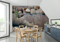 Stone Geometry wallpaper mural of cracked rock in a kitchen nook with round wood table and blue-grey cabinets