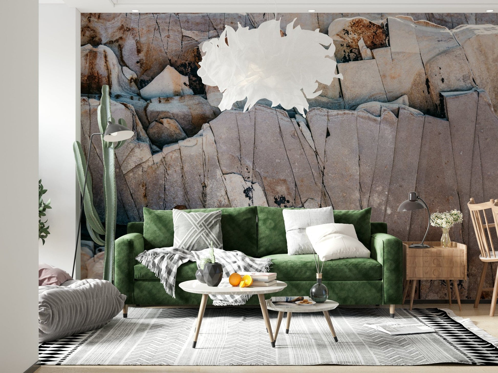Stone Geometry wallpaper mural of cracked beige rock behind a green velvet sofa and tall cactus in a living room
