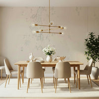 Subtle Texture wallpaper mural in cream plaster behind a wood dining table and brass linear chandelier