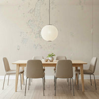Subtle Texture wallpaper mural in cream plaster behind a wood dining table and paper globe pendant