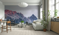 Sunset Mountain Vista wall mural behind a grey sofa and paper pendant lamp in a bright living room