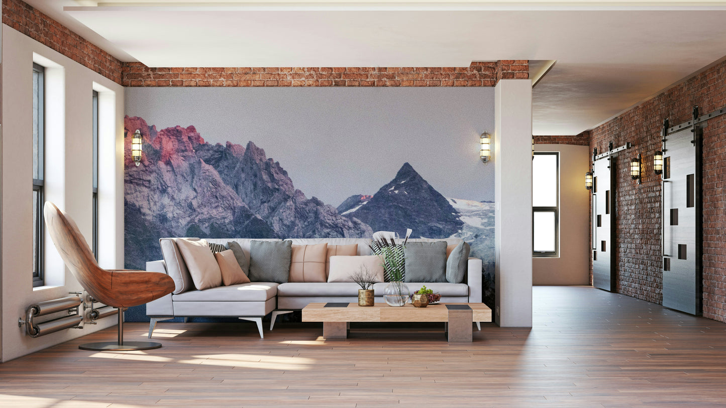 Sunset Mountain Vista wall mural on a brick-beam wall behind a grey sectional sofa in a loft living room