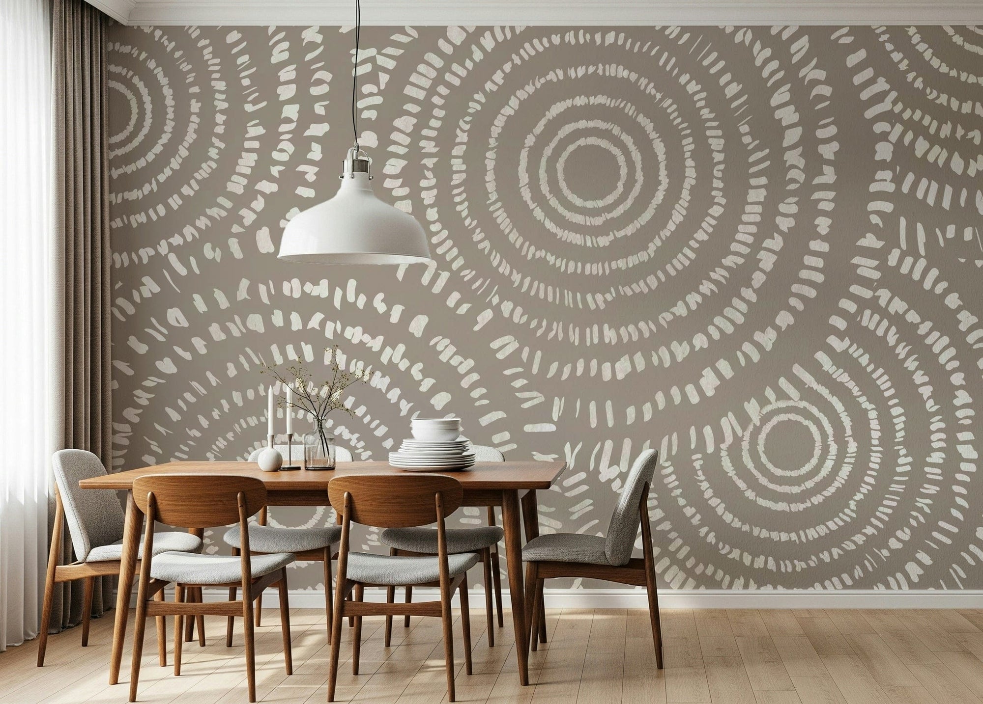 Concentric Echoes wallpaper mural in taupe with cream dotted circles behind a wood dining table and chairs