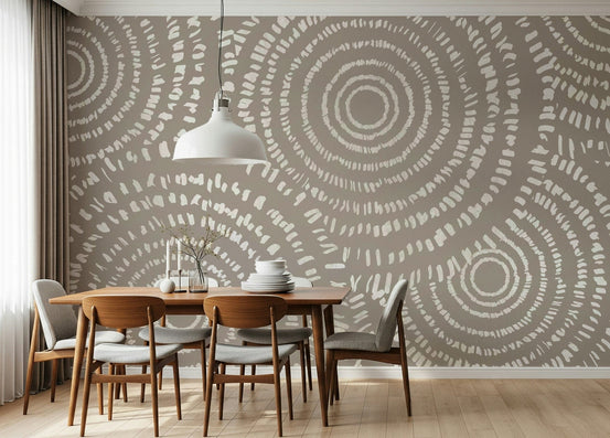 Concentric Echoes wallpaper mural in taupe with cream dotted circles behind a wood dining table and chairs
