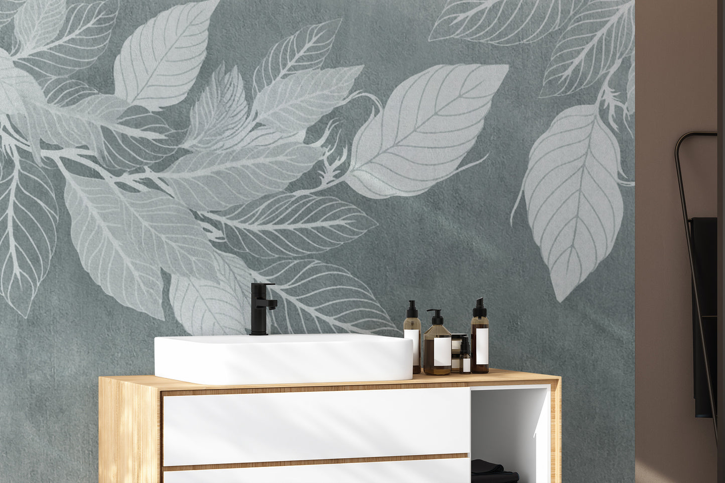 Elegant Teal Botanical Leaf wallpaper mural with white leaves behind a wood and white vanity with a black tap in a bathroom