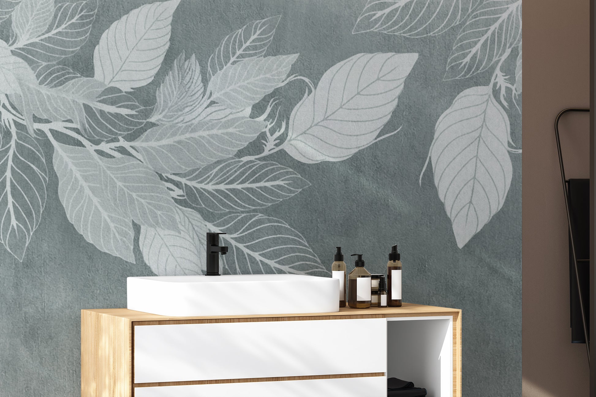 Elegant Teal Botanical Leaf wallpaper mural with white leaves behind a wood and white vanity with a black tap in a bathroom