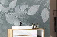 Elegant Teal Botanical Leaf wallpaper mural with white leaves behind a wood and white vanity with a black tap in a bathroom