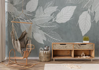 Elegant Teal Botanical Leaf wallpaper mural with white leaves behind a hanging chair and wooden console in a kids room