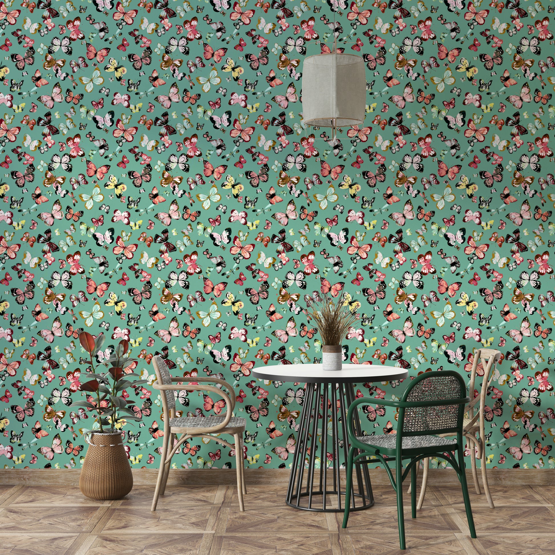 Flying Butterflies Colorful Teal Coral wallpaper behind a black round table with rattan and green dining chairs