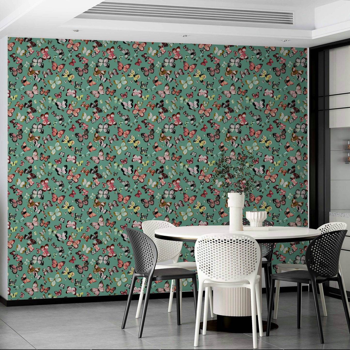 Flying Butterflies Colorful Teal Coral wallpaper behind a white round table with black and white dining chairs