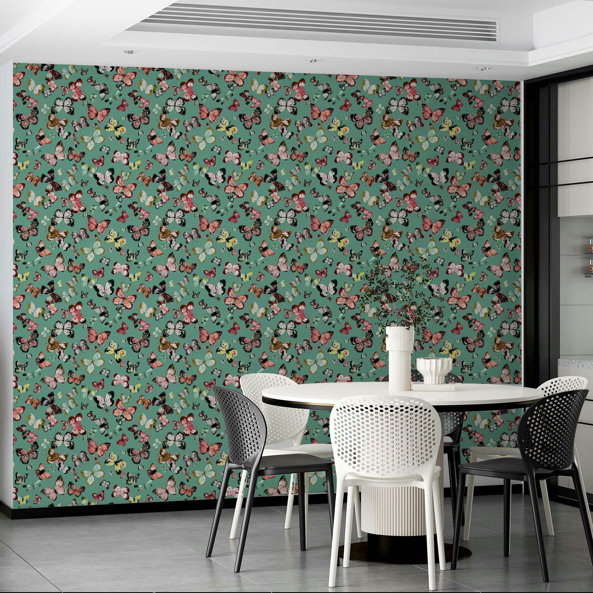 Flying Butterflies Colorful Teal Coral wallpaper behind a white round table with black and white dining chairs