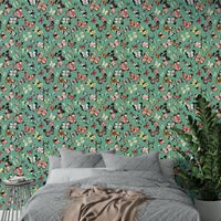 Flying Butterflies Colorful Teal Coral wallpaper above a grey quilted bed with beige throw and a green plant