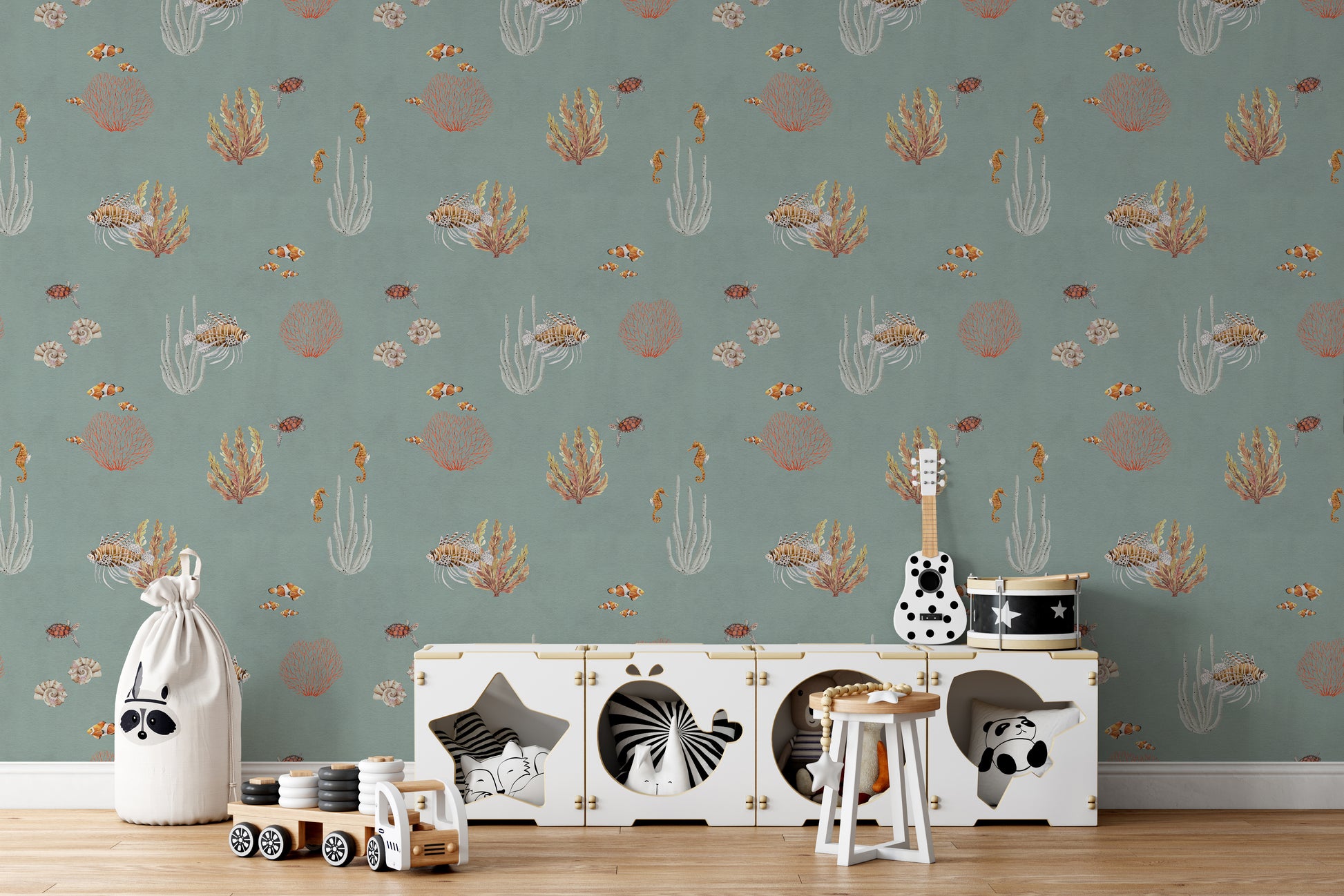 Teal Oceanic Wonders wall mural behind a white toy cabinet with a guitar and toy drum