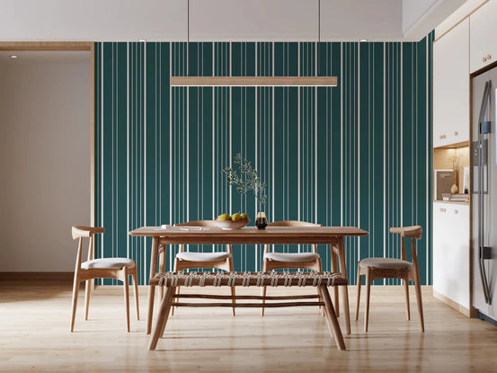 Teal Stripe wallpaper with cream vertical pinstripes behind a wood dining table, chairs and bench in a bright kitchen-diner