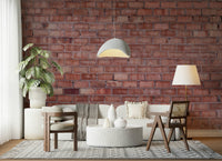 Textured brick wall wallpaper mural with warm red and orange tones for urban or farmhouse décor.
