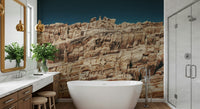 Dramatic cliff wall mural in deep terracotta and muted earth tones for accent walls in living spaces.