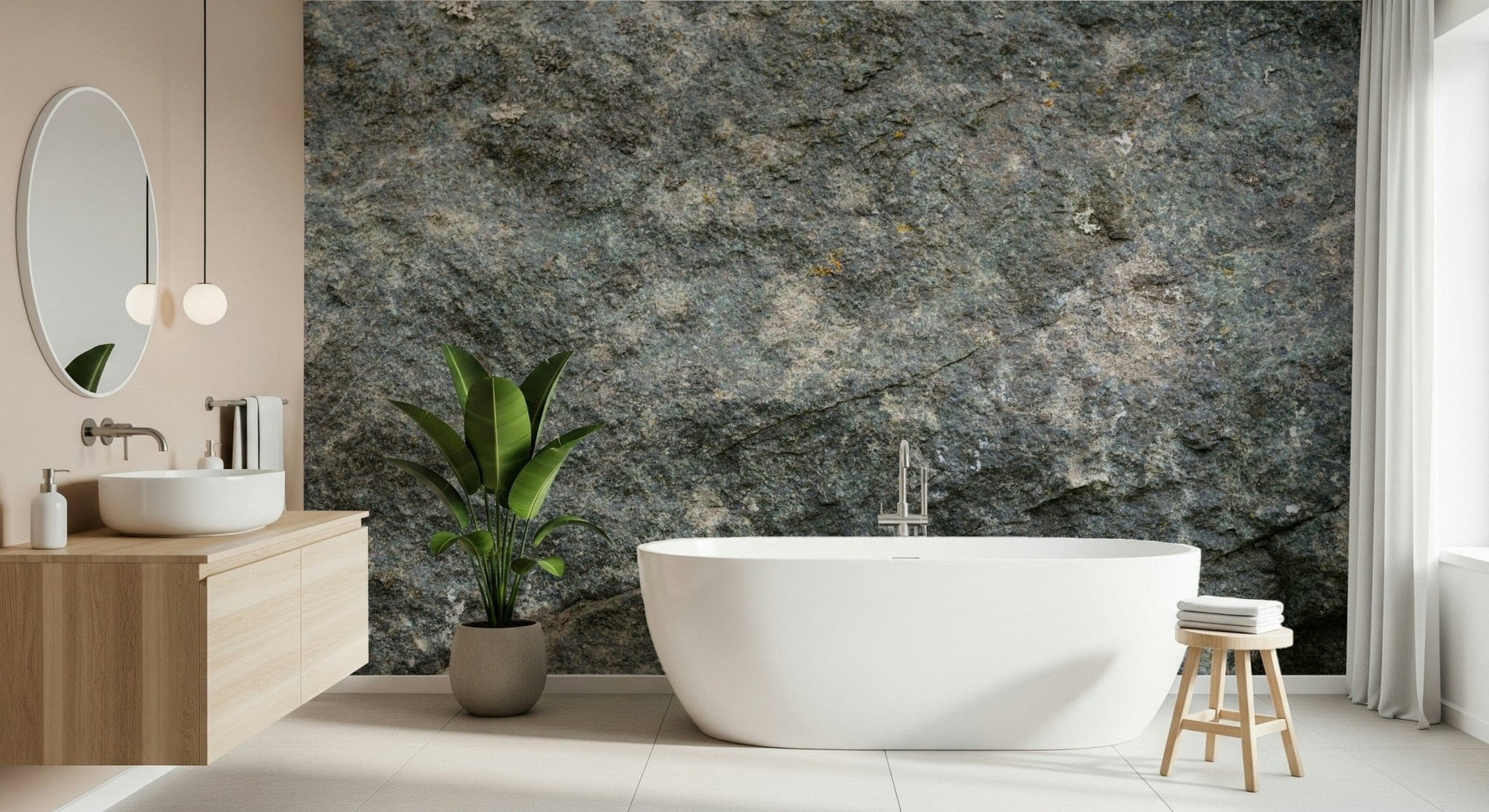 Textured Rock wallpaper mural in grey-green stone behind a freestanding white tub and wood vanity in a bathroom