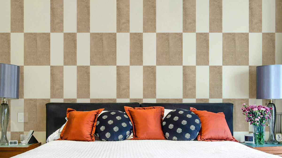 Textured Taupe & White wallpaper mural in a checkerboard print behind a navy bed with orange and blue pillows