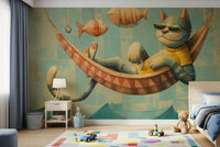 The Cat's Seaside Siesta wallpaper mural with a sunglassed cat in a hammock above a blue kids bed and toy-car rug