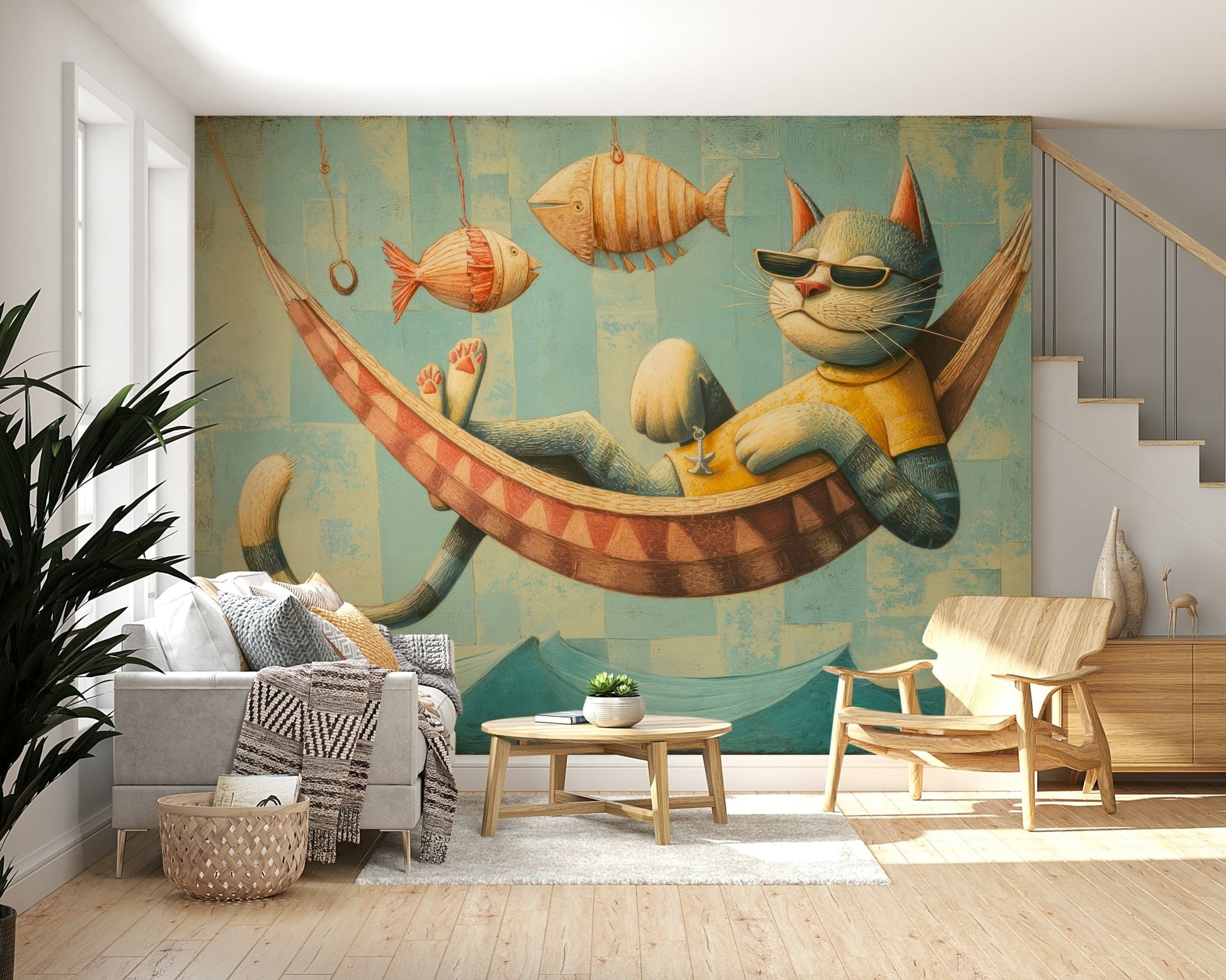 The Cat's Seaside Siesta wallpaper mural above a grey sofa and wood armchair beside a staircase in a living room